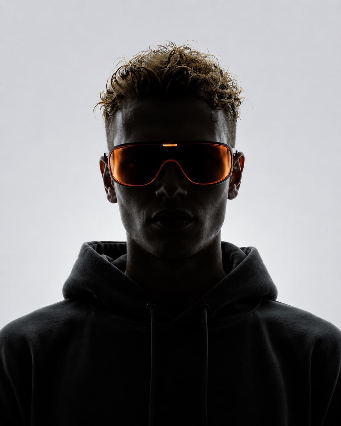 RISE hooded silhouette in an orange visor